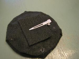 Glue down your clip if you're using one. I did this before assembling my two hat pieces.